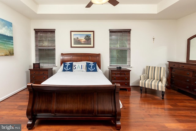 bedroom with ceiling fan and dark hardwood / wood-style floors