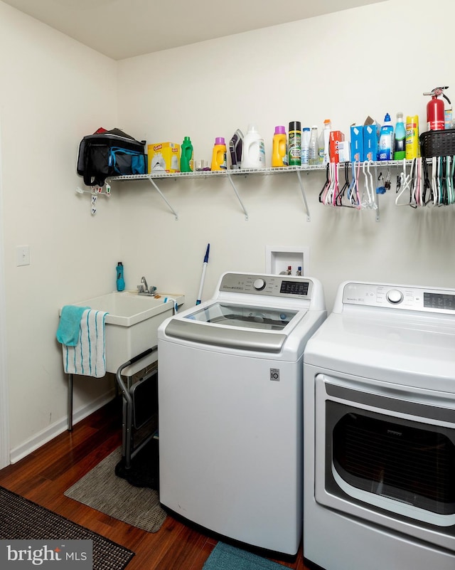 laundry room featuring separate washer and dryer and dark hardwood / wood-style flooring