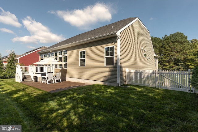 back of property with a patio area and a yard