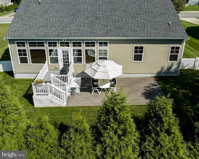 back of house featuring a patio area and a yard