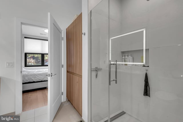 bathroom with tile patterned flooring and an enclosed shower