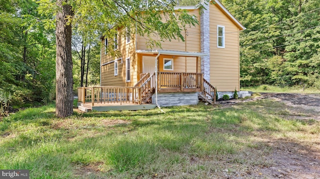 back of house with a wooden deck