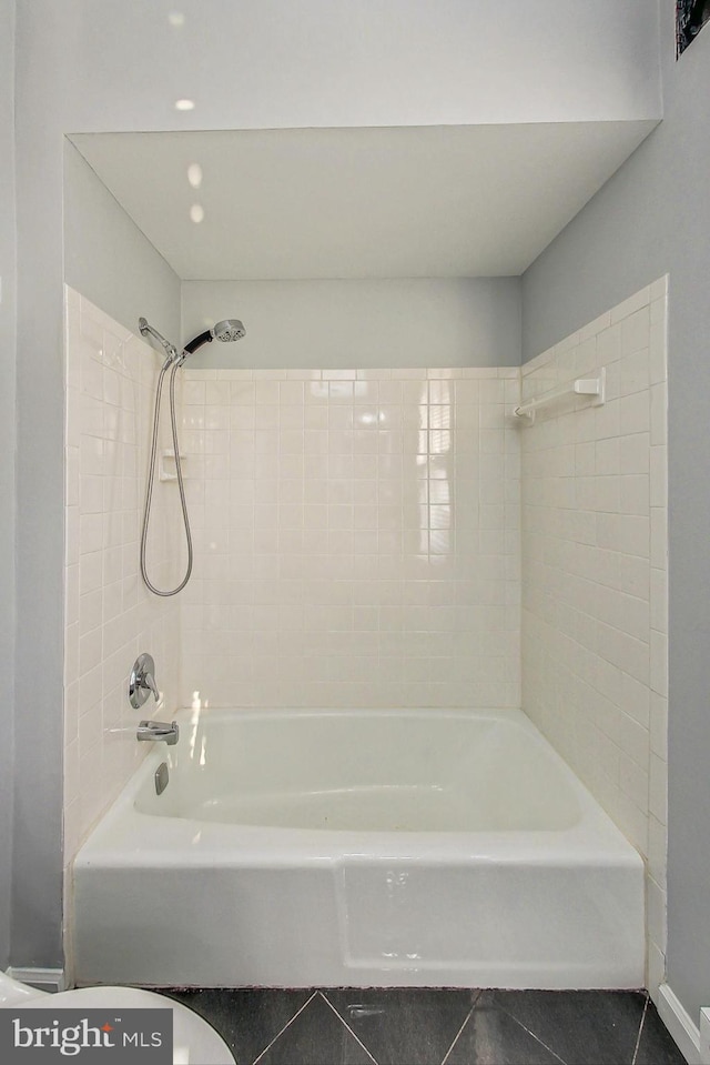 bathroom with tiled shower / bath combo and tile patterned floors