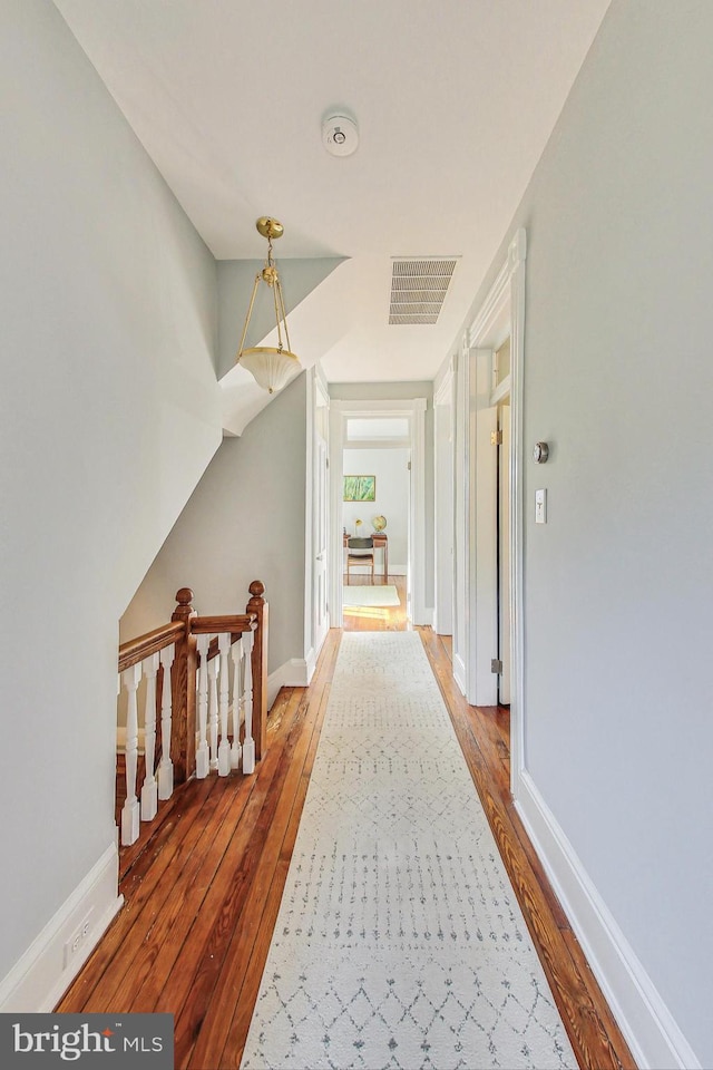 hall with hardwood / wood-style flooring