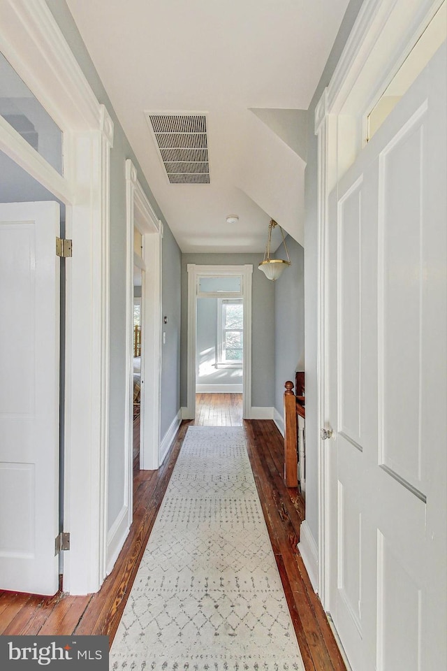 corridor featuring dark wood-type flooring