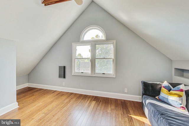 additional living space with ceiling fan, light hardwood / wood-style flooring, and vaulted ceiling