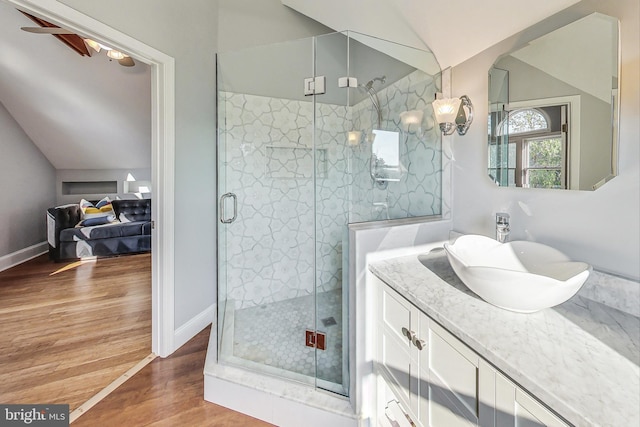 bathroom featuring hardwood / wood-style flooring, walk in shower, and vanity