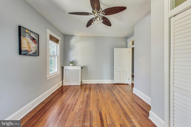 spare room featuring ceiling fan and hardwood / wood-style flooring