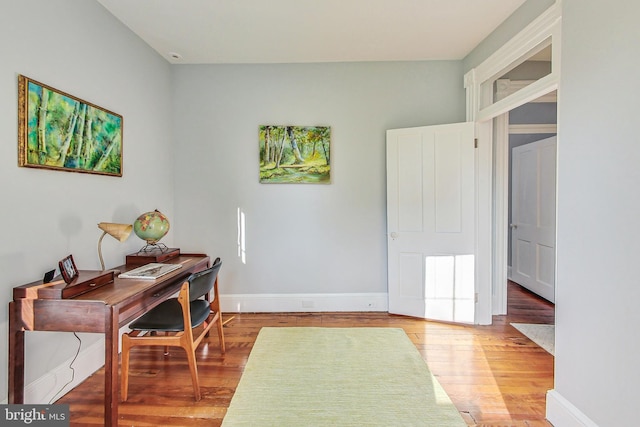 home office with wood-type flooring