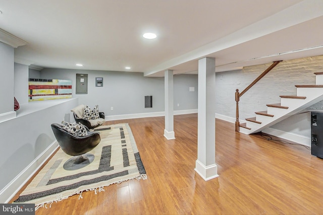 basement with wood-type flooring and electric panel