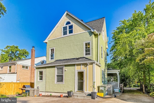 rear view of property featuring central AC