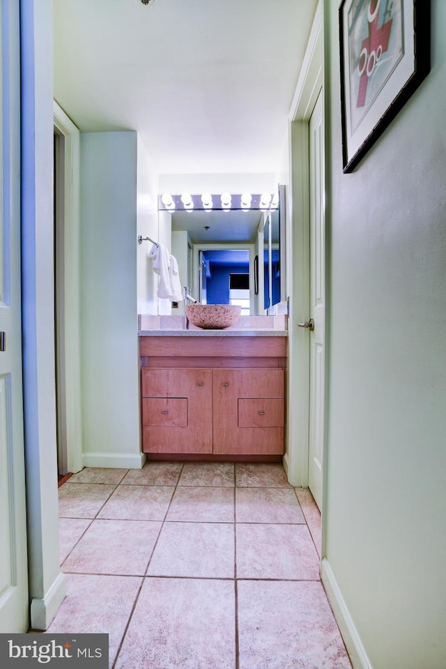 bathroom featuring tile patterned flooring, vanity, and baseboards