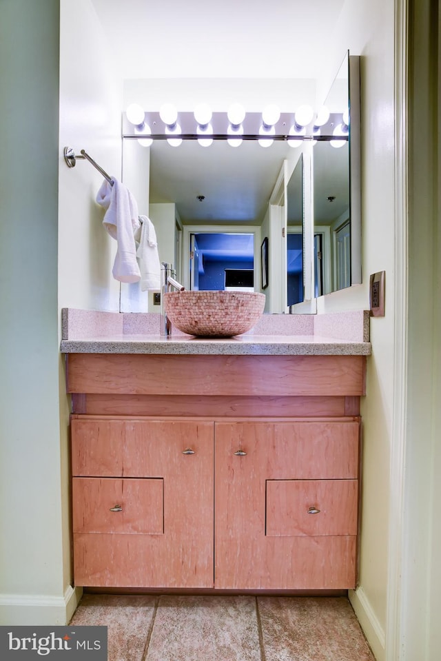 bathroom featuring vanity and baseboards