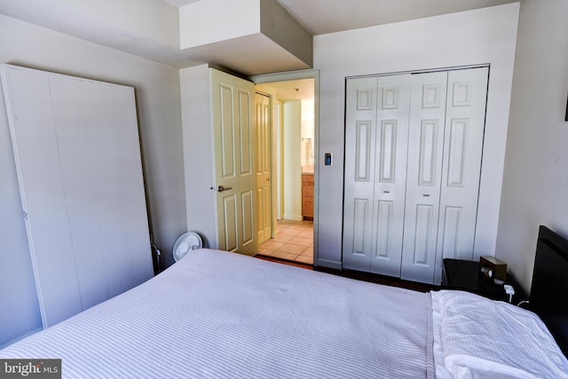 bedroom with a closet and tile patterned floors