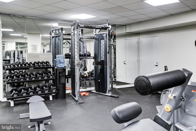 exercise room featuring a drop ceiling