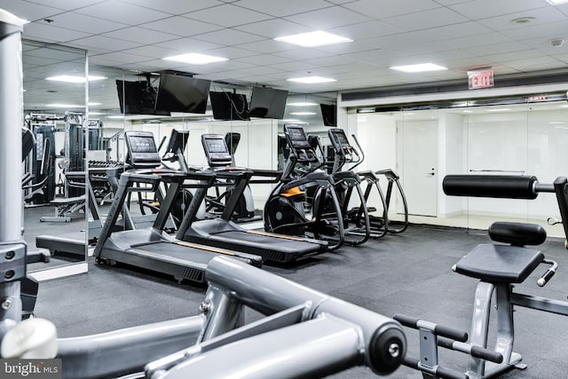 workout area with a paneled ceiling