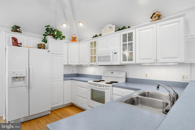 kitchen featuring white cabinets, light hardwood / wood-style flooring, vaulted ceiling, white appliances, and sink