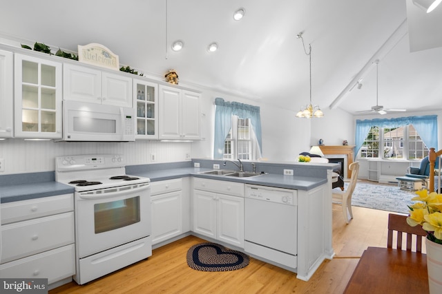 kitchen with decorative light fixtures, ceiling fan with notable chandelier, white appliances, light hardwood / wood-style floors, and white cabinetry