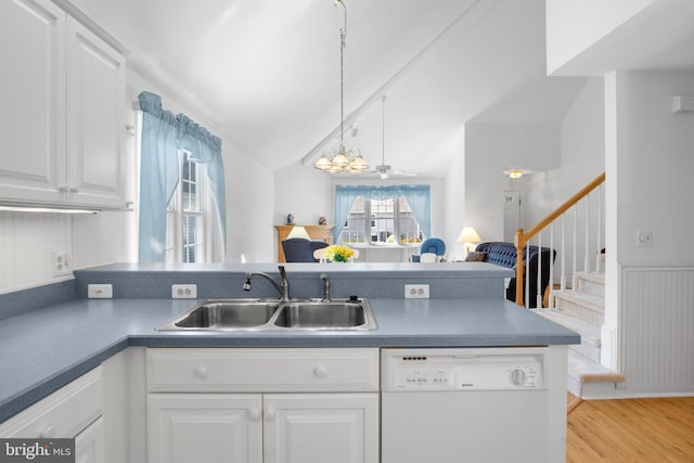 kitchen with white cabinetry, light hardwood / wood-style flooring, decorative light fixtures, dishwasher, and sink