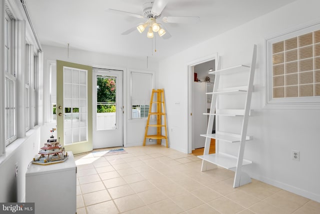 tiled entrance foyer with ceiling fan