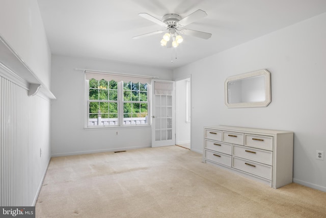 unfurnished bedroom with ceiling fan and light carpet