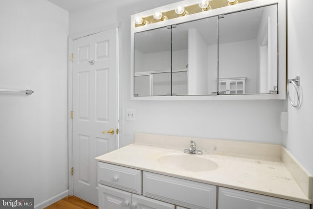 bathroom with vanity and wood-type flooring