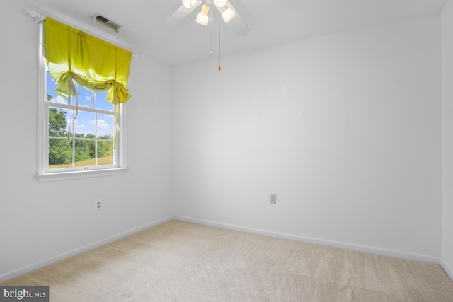 unfurnished room featuring ceiling fan and light carpet