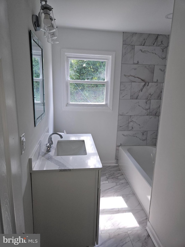 bathroom with marble finish floor, baseboards, and vanity