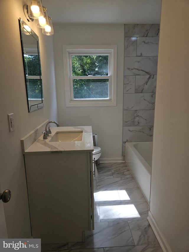 bathroom with marble finish floor, vanity, toilet, and baseboards