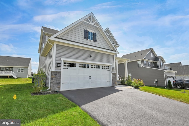 craftsman-style house featuring a garage and a front yard