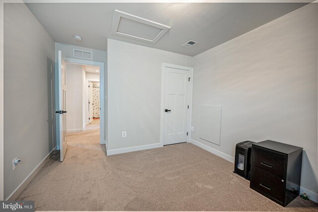 unfurnished bedroom featuring light carpet