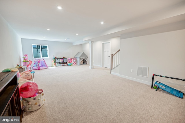 recreation room with light carpet