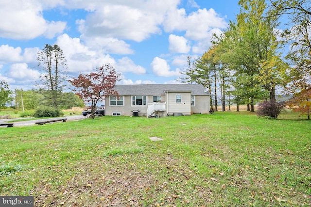 back of property with a lawn