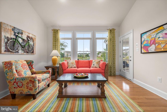 living room with vaulted ceiling and hardwood / wood-style floors