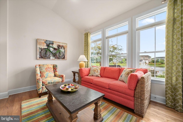 living room featuring plenty of natural light, vaulted ceiling, and hardwood / wood-style floors