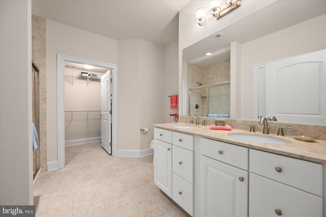 bathroom with double vanity, a sink, visible vents, and a shower stall