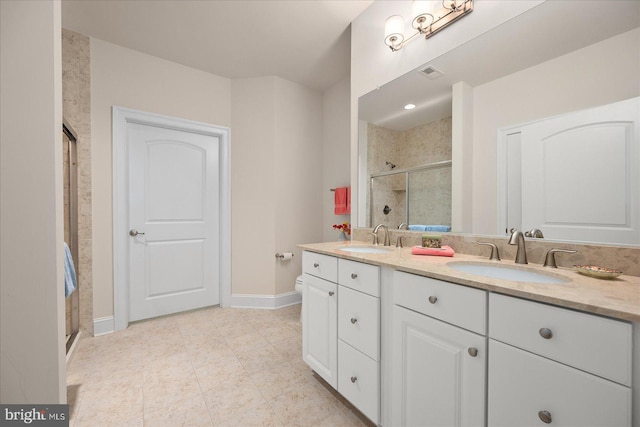 full bath with double vanity, a stall shower, visible vents, and a sink