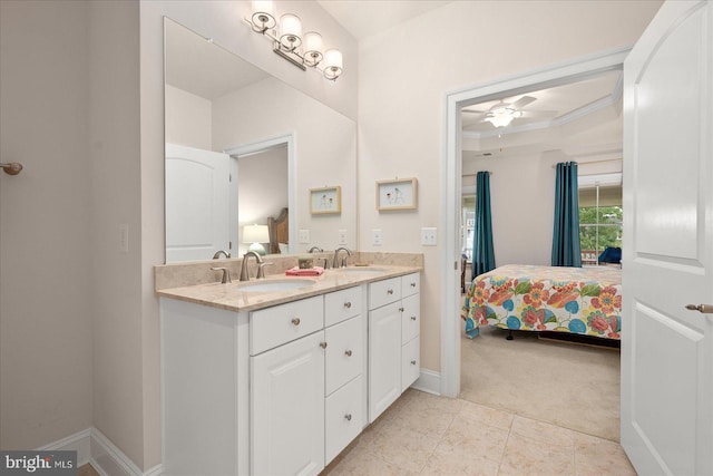 bathroom featuring tile patterned floors, a raised ceiling, vanity, ceiling fan, and ornamental molding