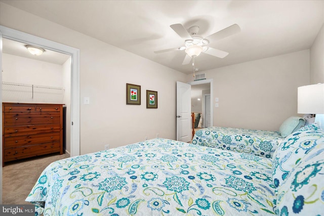 bedroom featuring carpet floors, visible vents, and a ceiling fan