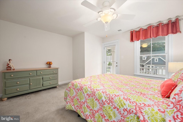 carpeted bedroom with baseboards, multiple windows, visible vents, and a ceiling fan