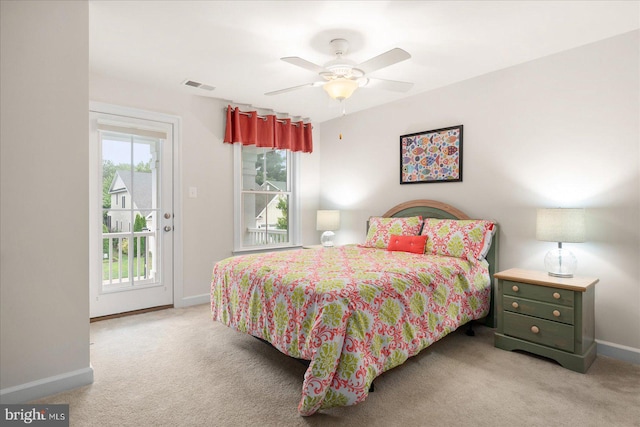 carpeted bedroom featuring access to exterior, ceiling fan, and multiple windows