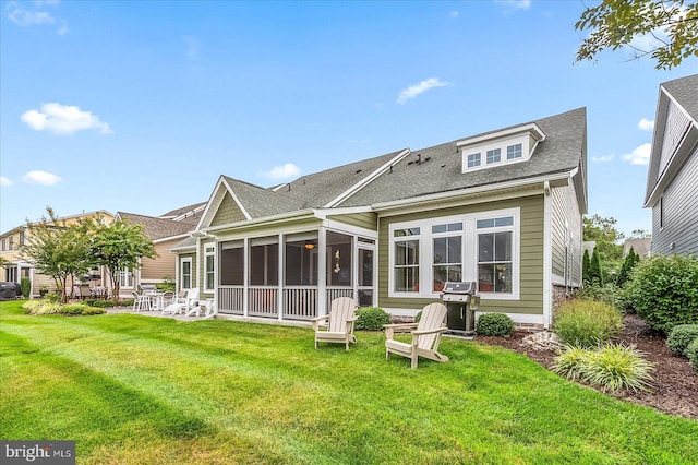 back of property featuring a sunroom, a lawn, and a patio