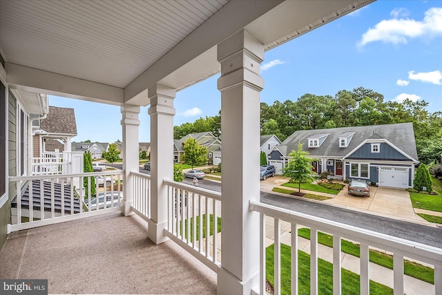 balcony featuring covered porch and a residential view