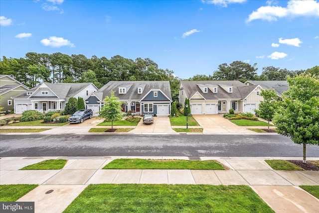 view of front of property with a residential view, concrete driveway, and a front yard