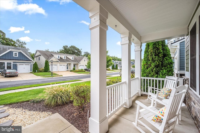 view of patio / terrace featuring a garage and a porch