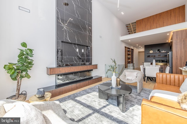 living room with high vaulted ceiling and a large fireplace