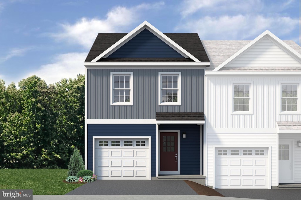 view of front of home featuring a garage and aphalt driveway