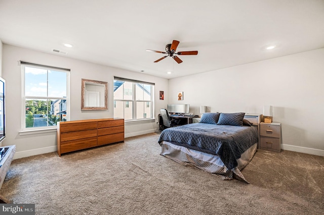 carpeted bedroom featuring multiple windows, recessed lighting, and baseboards