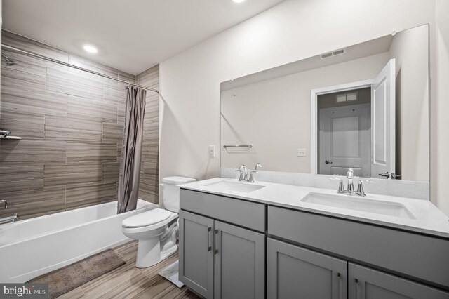 full bathroom with vanity, toilet, and shower / bath combination with curtain