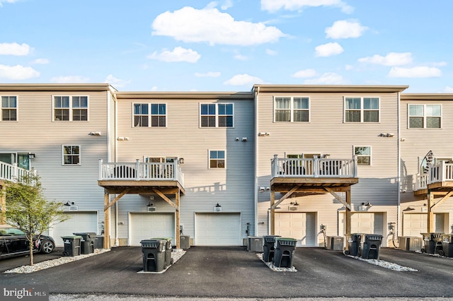 view of building exterior with a garage and central AC